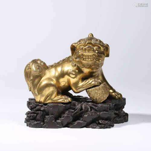A CHINESE GILT-BRONZE LION AND STAND
