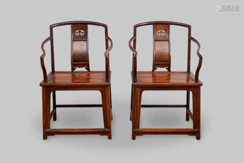 A pair of low-back continuous yoke-back armchairs 20th centu...