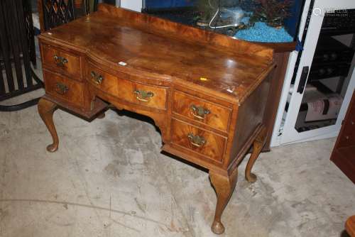 A 1920's figured mahogany bow front dressing table with cros...