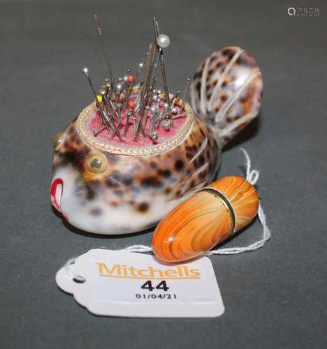 A Cowrie shell pin cushion, model as a fish,