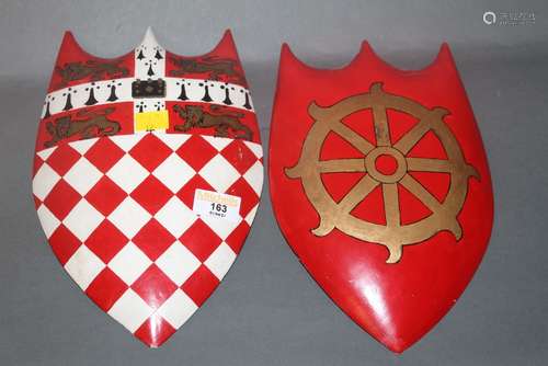 A painted wooden shield with red and white lozenge dipper an...