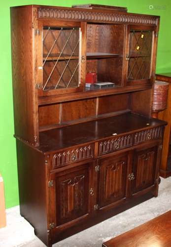 An oak dresser of 18th century design the upper part enclose...