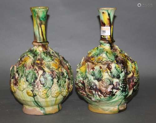 A pair of leaf moulded pottery bulbous vases of Majolica sty...