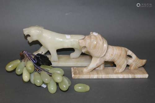 A bunch of carved pale green nephrite and dark green jade gr...