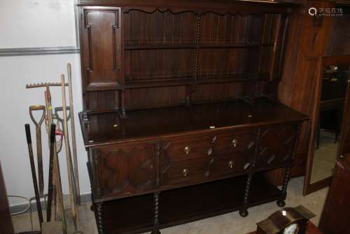 A 1920's oak dresser fitted two drawers and cupboards with m...