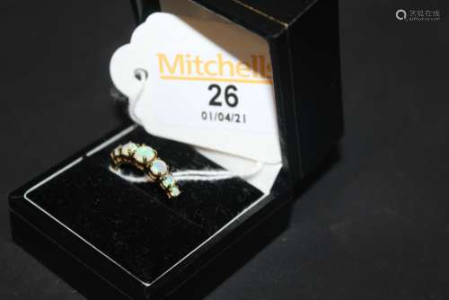 A 9ct gold and opal ring set with seven graduated circular c...