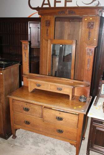An Arts and Crafts oak 2 piece bedroom suite with carved flo...