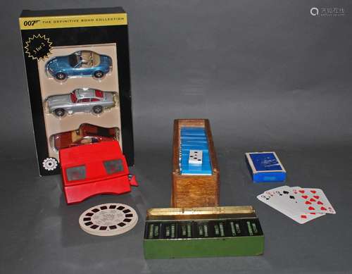 A box of vintage games and diecast James Bond cars