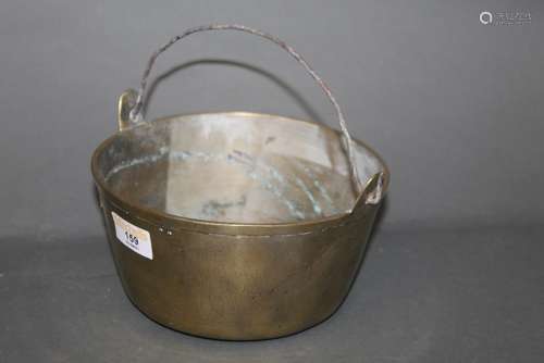 An early 19th century bell metal jam pan with wire handle,