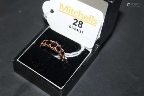 A gold coloured metal (thought 9ct), and garnet set ring of ...