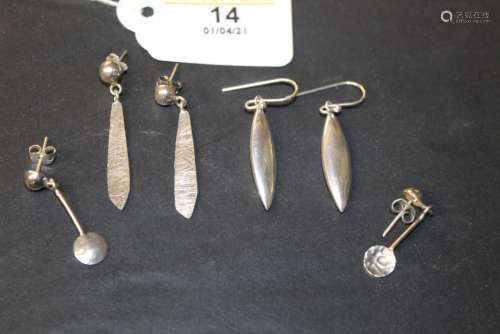 Three pairs of silver earrings, comprising hammered disc pat...