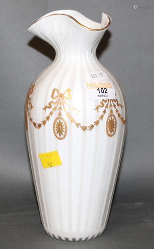 An early 20th century cased white glass baluster shaped vase...