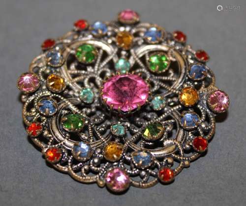 A vintage gilt and silvered metal multi coloured stone brooc...