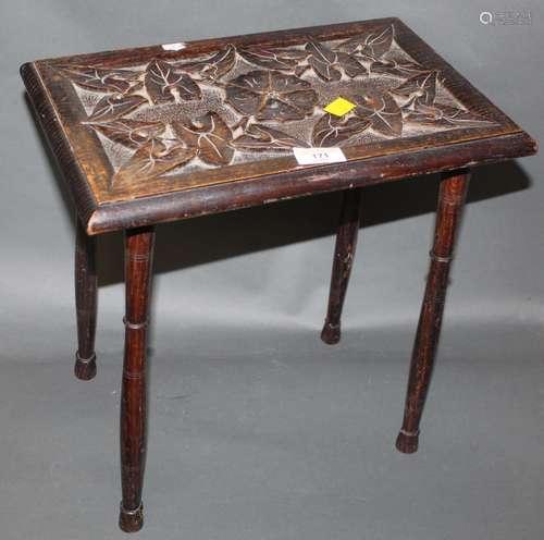 An Edwardian leaf carved oak rectangular stool on slender tu...