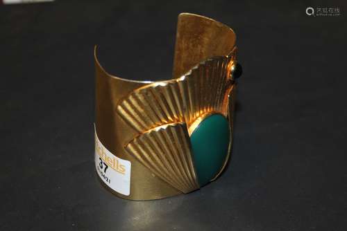 A gilt metal and enamelled cuff of Art Deco design with scal...