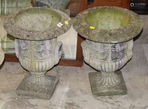 A pair of cast composite stone garden campana style urns,
