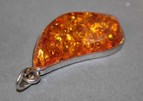 A large white metal and amber (probably reconstituted) oval ...