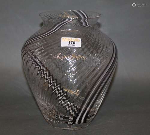 A Caithness clear glass bulbous vase, the spiralled body wit...