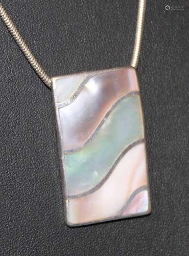 A silver and mother of pearl rectangular pendant with silver...