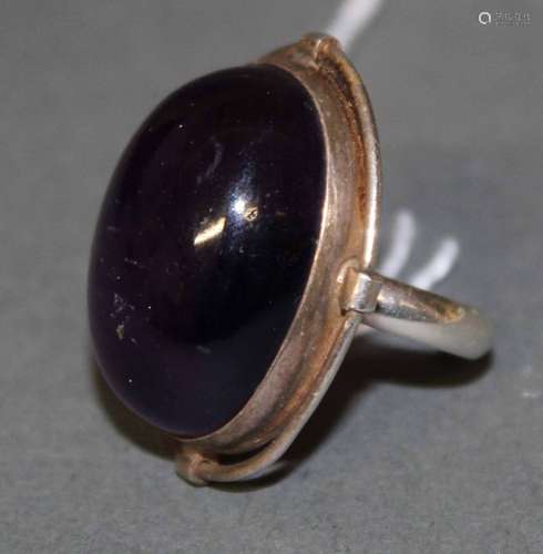 A silver and cabochon amethyst ring the amethyst 3 cm x 2 cm...