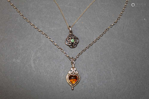 A silver and amber heart shaped pendant of Art Nouveau desig...