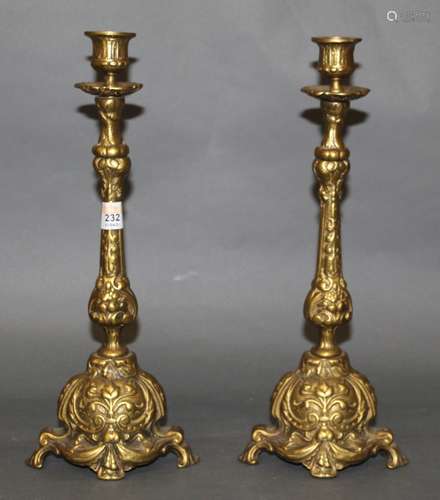 A pair of cast brass pillar candlesticks of 18th century des...