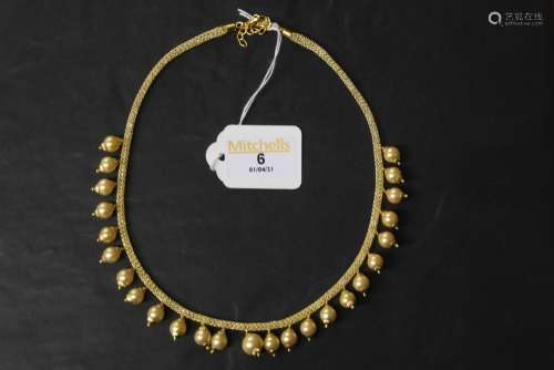 A filigree gilt metal and golden pearl necklace,