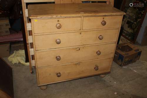 A Victorian stripped pine chest of drawers on turned feet,