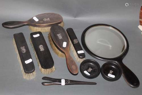 An early 20th century ebony eight piece dressing set,