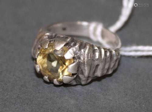 A silver and citrine ring the textured shank with claw mount...