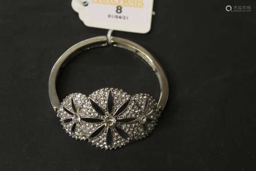 A white metal and CZ bangle of Art Deco design with pierced ...