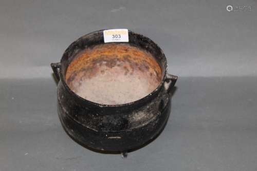 A cast iron cauldron, of traditional form, with small triang...