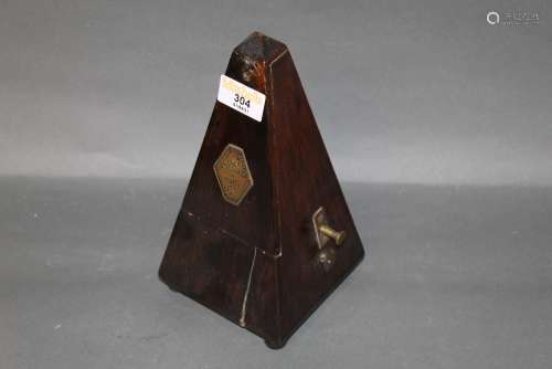 An antique stained wood cased metronome, with applied brass ...