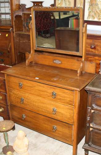 A 1930's oak dressing chest with rectangular mirror,