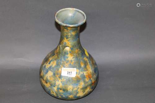 A 20th century pottery bottle shaped vase, decorated in mott...