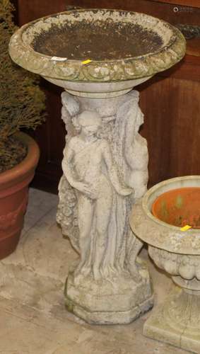 A cast composite stone bird bath,