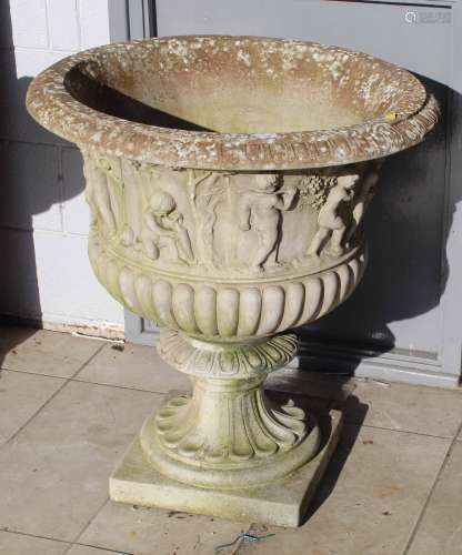 A large cast composite stone garden campana style urn,