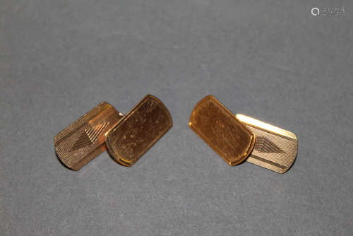 A pair of 9ct gold cuff links, with geometrically engraved r...