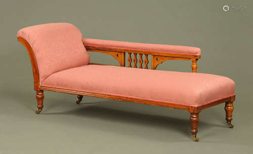 A Victorian oak chaise longue,