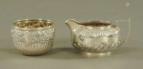 A silver cream jug, Sheffield 1892, together with a sugar ba...