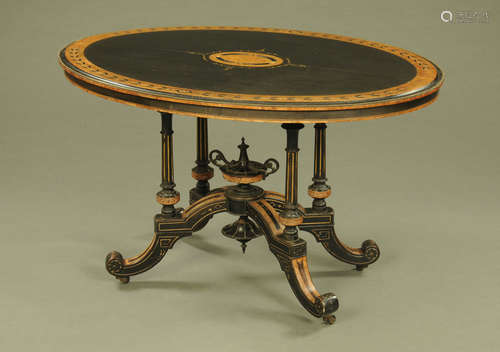 A Victorian oval aesthetic movement inlaid and ebonised cent...