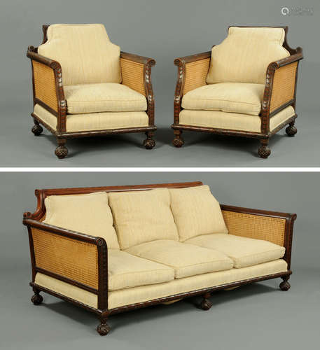 An early 20th century mahogany three piece bergere lounge su...