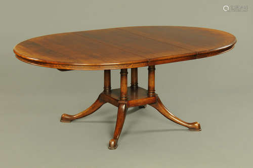 A Stewart Linford oak dining table, with centre pedestal and...