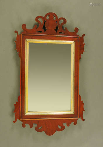 A George III mahogany fretwork wall mirror, with gilt slip. ...