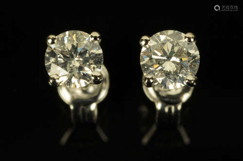 A pair of 18 ct white gold diamond stud earrings, total diam...