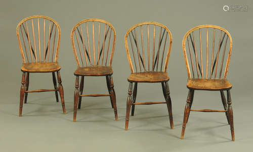 A set of four Windsor dining chairs, each with solid seat, t...