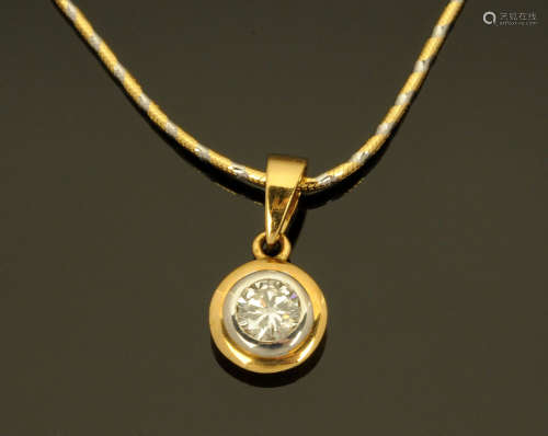 An 18 ct two tone gold pendant on chain, rubover set with a ...
