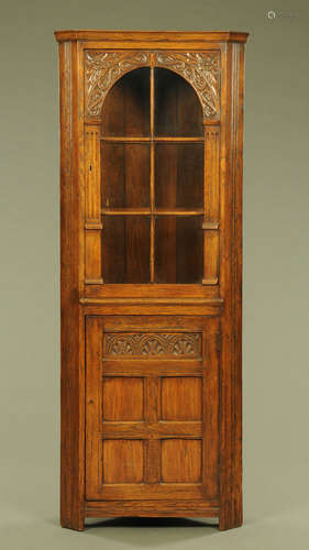 An Ipswich oak standing corner cupboard, with glazed upper s...