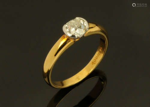 An 18 ct two tone gold ring, semi rubover set with an old cu...