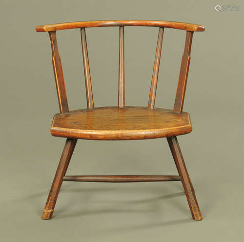 A 19th century oak low occasional chair, with bowed top rail...